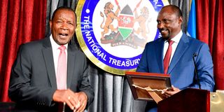 New ICT cabinet secretary Eliud Owalo receives documents from his predecessor Eliud Owalo